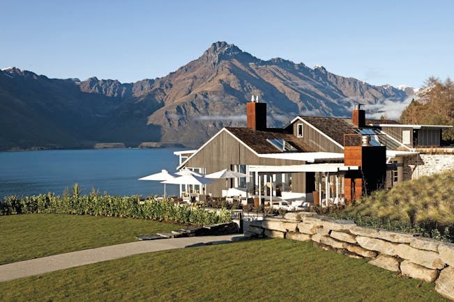 Matakauri Lodge Otago and Fiordland exterior wooden chalet with garden and mountain view
