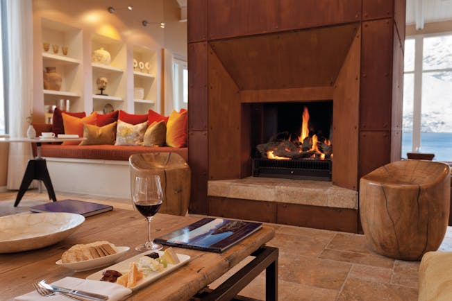 Matakauri Lodge Otago and Fiordland upper lounge area with sofa fireplace and mountain view