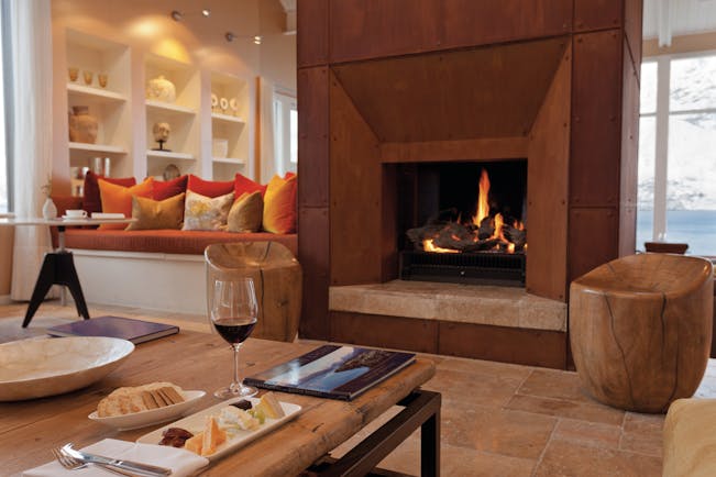 Matakauri Lodge Otago and Fiordland upper lounge area with sofa fireplace and mountain view