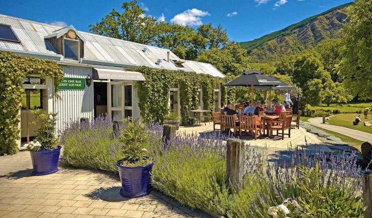 Millbrook Lodge Otago and Fiordland outdoor dining corrugated metal building with outdoor seating area and lavender
