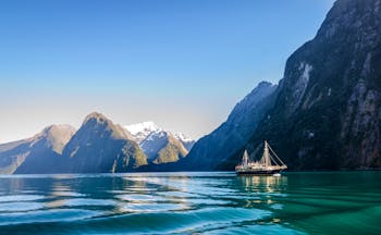 Milford Sound in Fiordland, blue waters, looming mountains