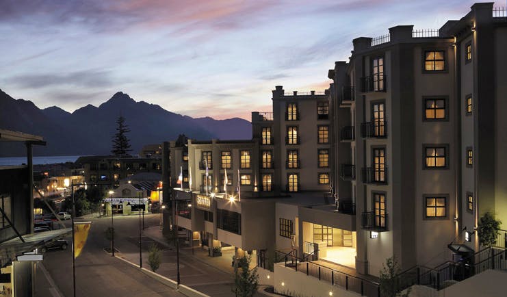 Sofitel Queenstown Otago and Fiordland outside night building with mountain in the distance