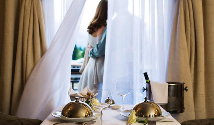 Sofitel Queenstown Otago and Fiordland room service couple standing in front of a window with room service