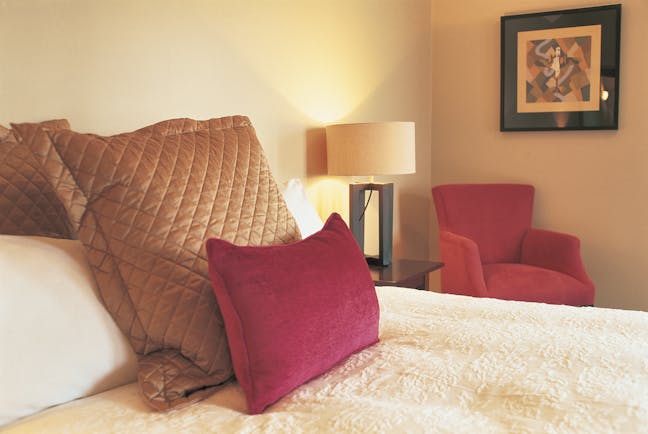 Bedroom at The Dairy with a cream and pink colour scheme