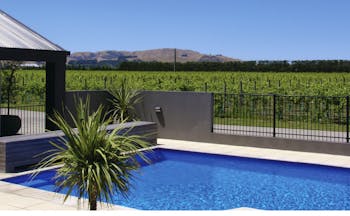 Peppers Parehua Wairarapa outdoor pool with vineyard and mountain view
