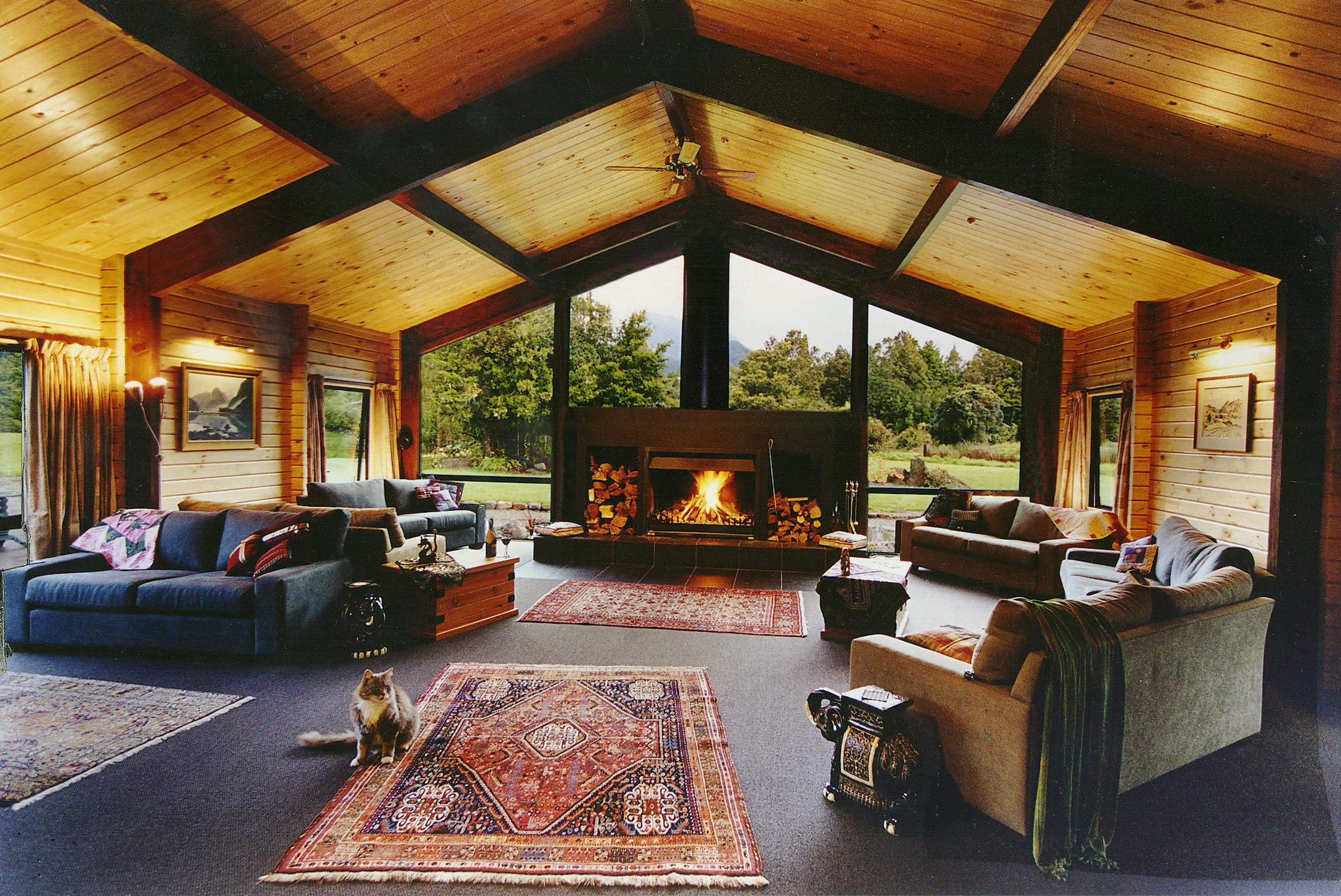 Lounge at Westwood Country House, sofas, roaring open fire, wide windows with views across the gardens