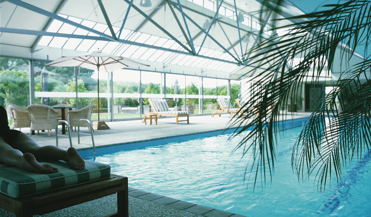 Wharekauhau Lodge Wairarapa indoor pool woman lying on a lounger