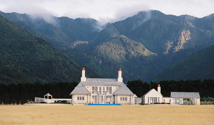 Wharekauhau Lodge Wairarapa lodge mountain exterior view of lodge complex in front of wooded mountains