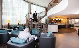 Bolton Hotel Wellington lobby couple walking down stairs to lobby with seating area