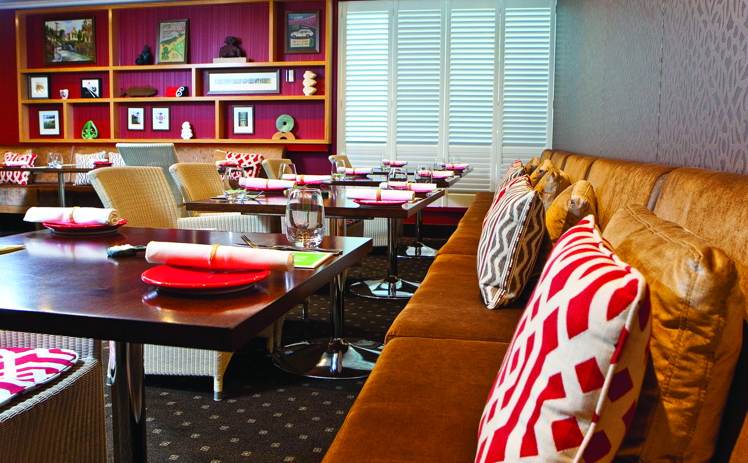 Bolton Hotel Wellington restaurant with red wall and bookshelf