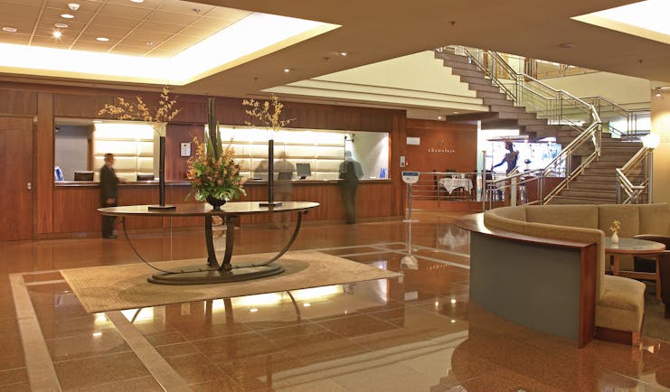 The Intercontinental Wellington lobby area with reception desk seating area and staircase