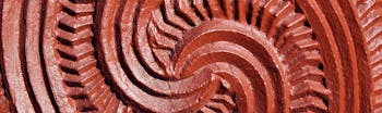 Red carving on Maori statue