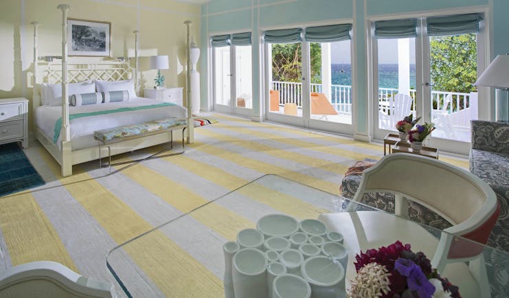 Malliouhana junior suite with pastel colour scheme and balcony with sea view