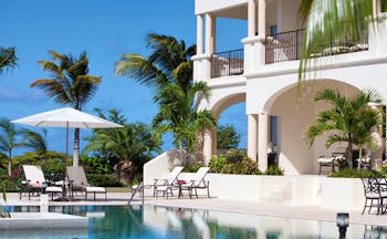 Blue Waters Antigua cove suites exterior pool and sun loungers 