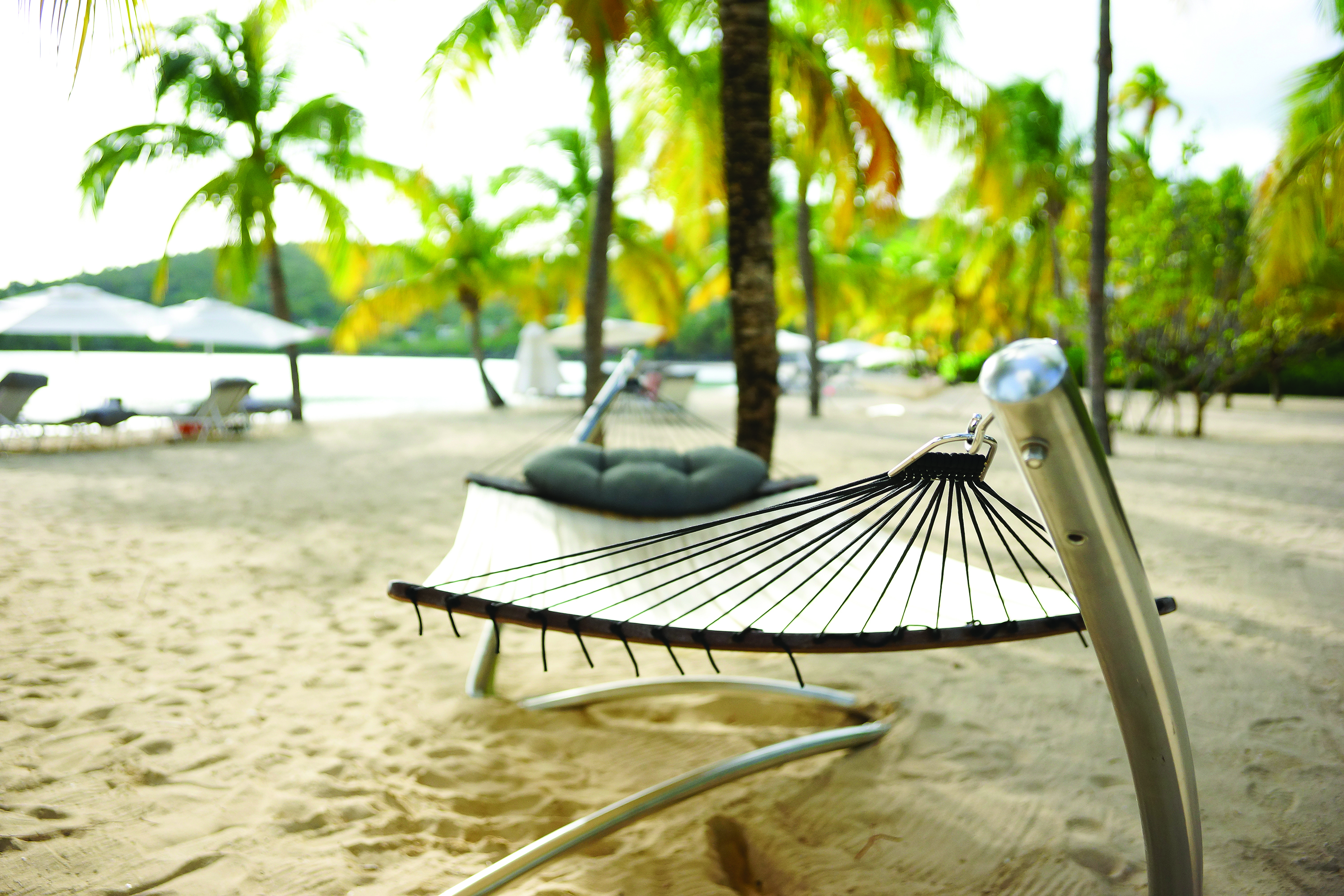 Carlisle Bay Antigua hammock on beach with palm trees