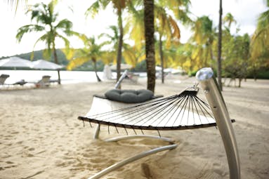 Carlisle Bay Antigua hammock on beach with palm trees