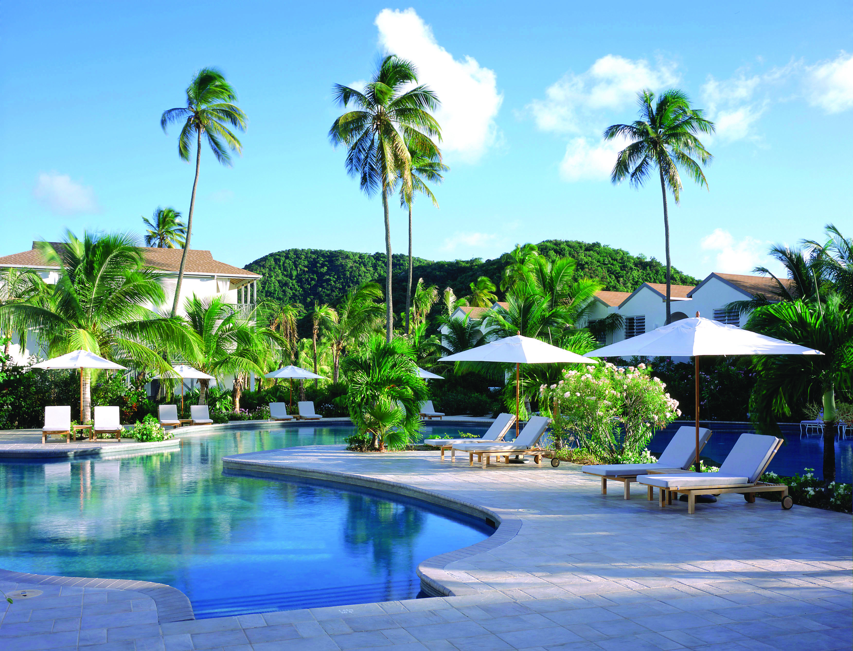 Carlisle Bay Antigua pool palm trees and sun loungers