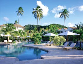 Carlisle Bay Antigua pool palm trees and sun loungers