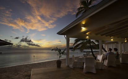 Evening scene on beach in open air restaurant
