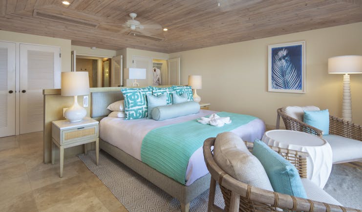 Bedroom with turquoise and white covers