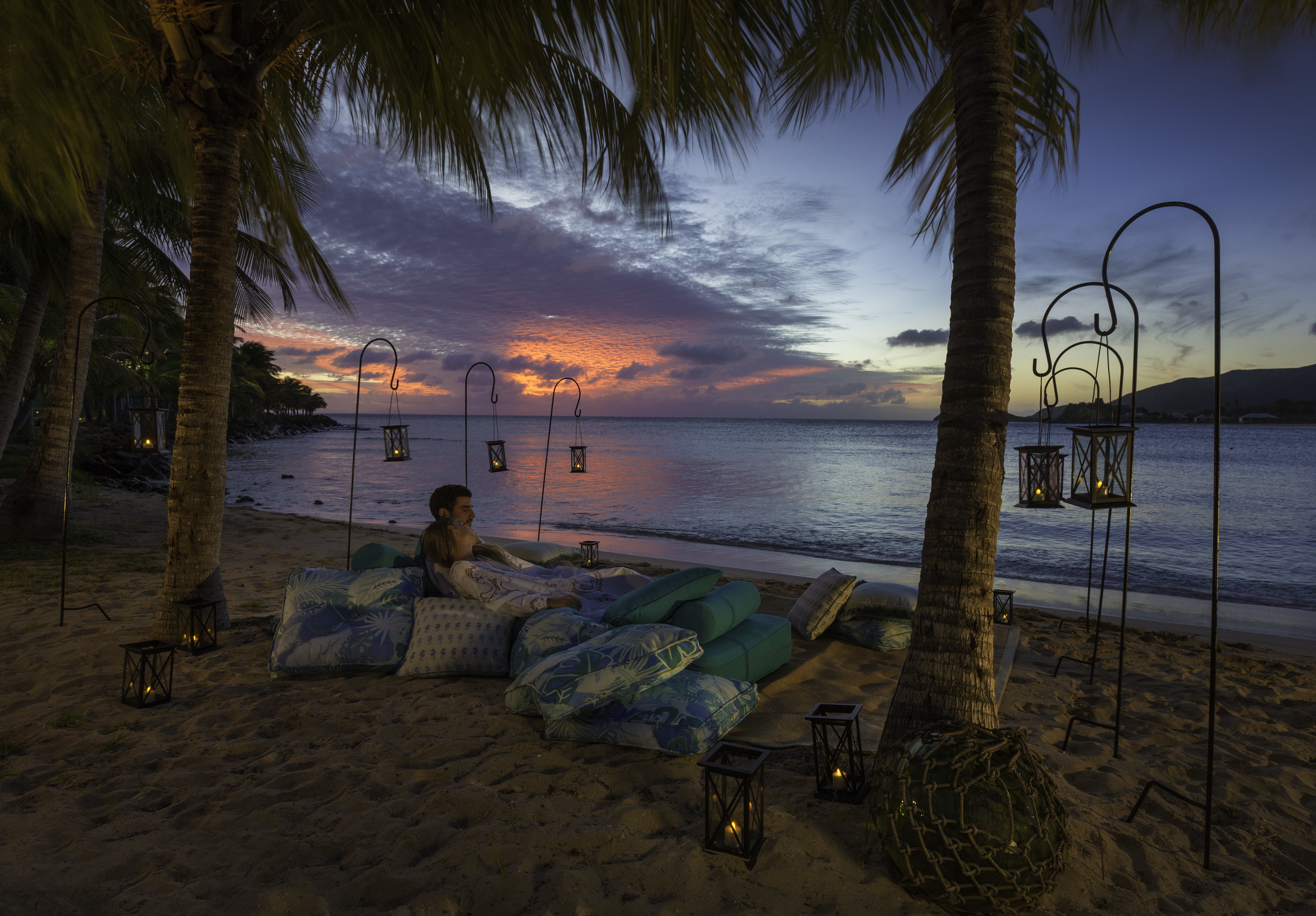 Evening with people on cushions on beach