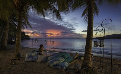 Evening with people on cushions on beach