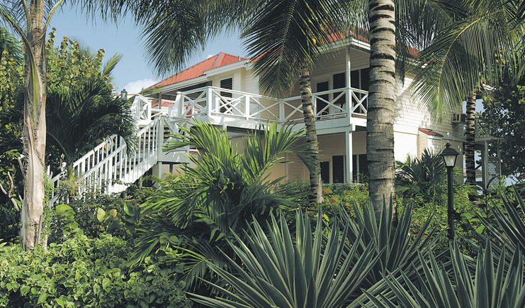 Galley Bay Antigua deluxe rooms exterior building surrounded by palm trees and greenery