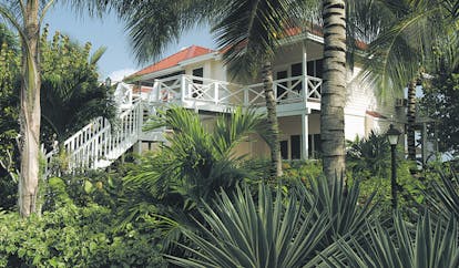 Galley Bay Antigua deluxe rooms exterior building surrounded by palm trees and greenery