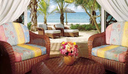 Galley Bay Antigua premium suite terrace armchairs leading to private beachfront terrace sun loungers