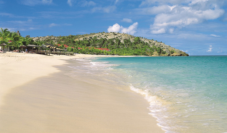 Galley Bay Antigua shore clear blue waves lapping sandy beach