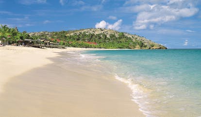 Galley Bay Antigua shore clear blue waves lapping sandy beach