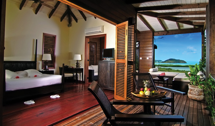 Hermitage Bay Antigua hillside cottage interior bed terrace side views of ocean