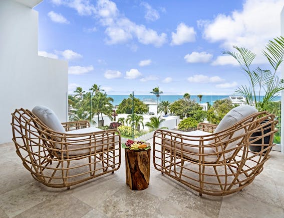Hodges Bay Resort junior suite balcony, two armchairs, views overlooking the sea