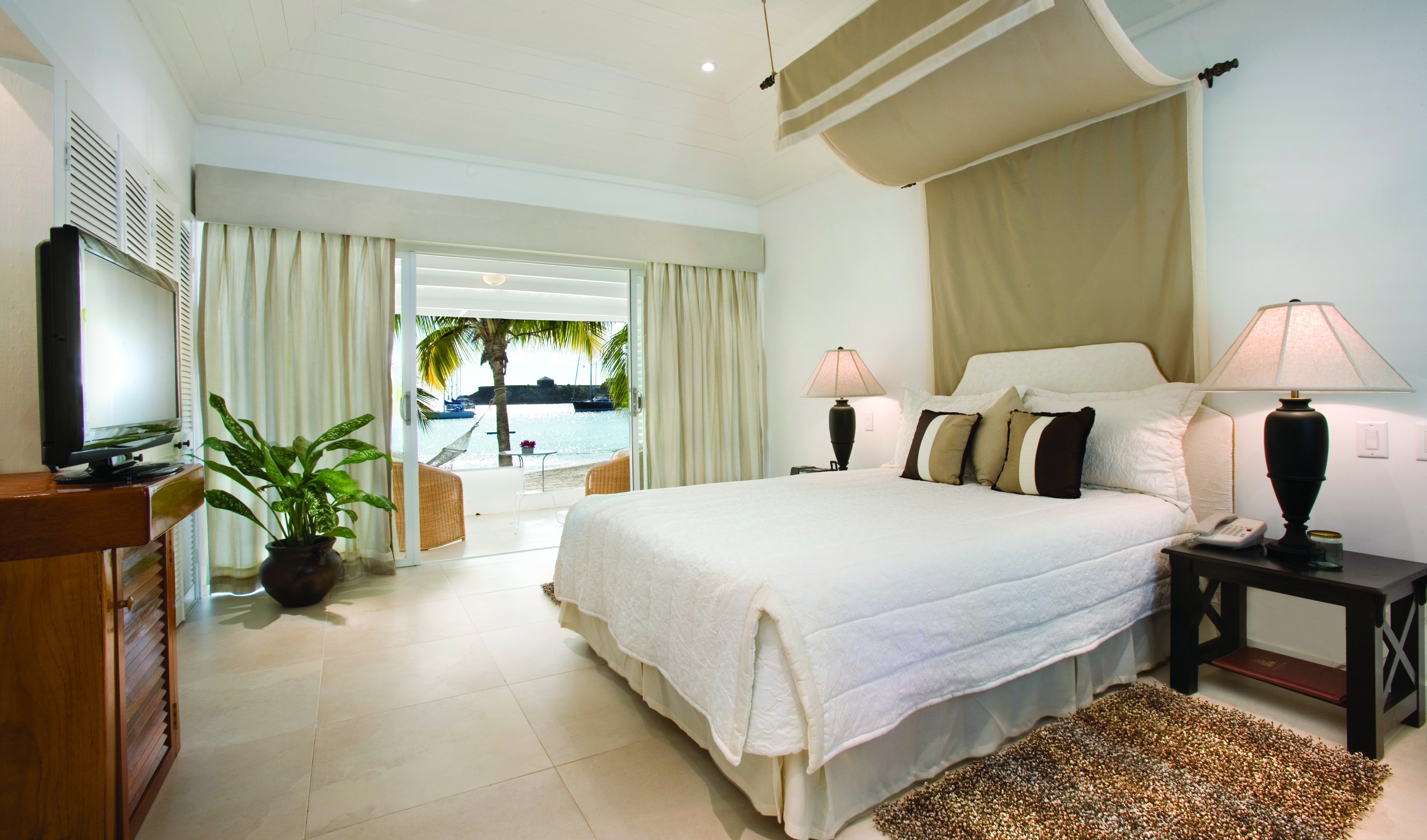Inn at English Harbour Antigua beach cabana bedroom opening up to beach views