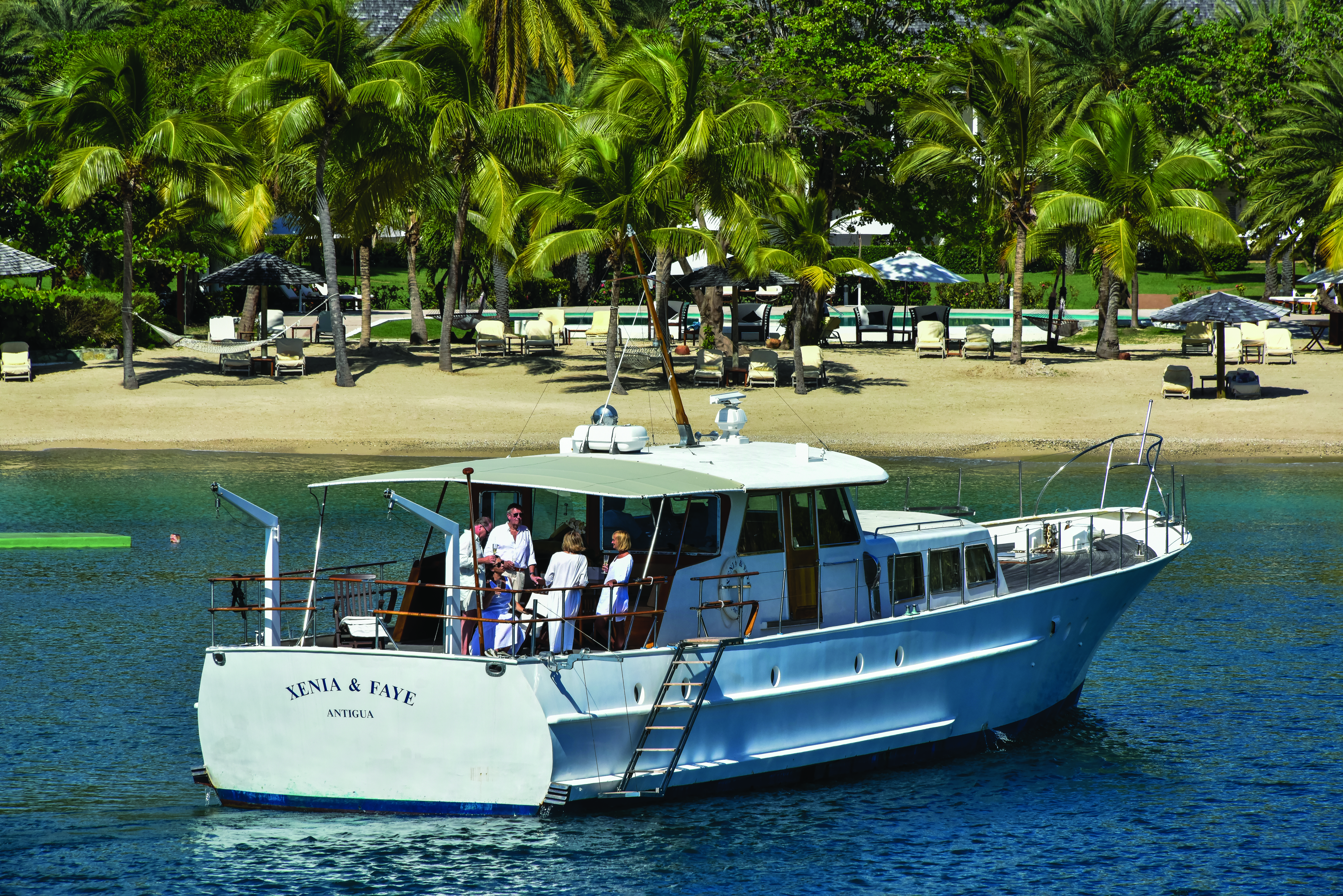 Inn at English Harbour Antigua boat on the water sandy beach in the background