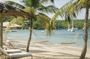 Inn at English Harbour Antigua hammock on beach beside the ocean palm trees 