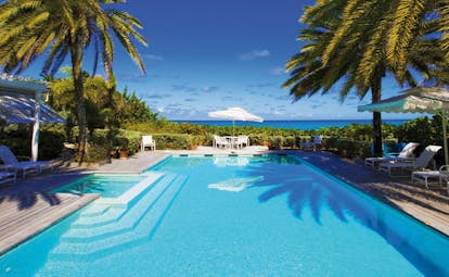 Jumby Bay Antigua bananaquit private residence private pool sun loungers palm trees