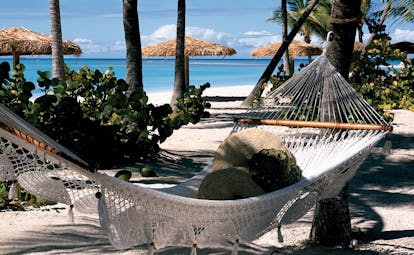 Jumby Bay Antigua beach hammock palm trees white sand
