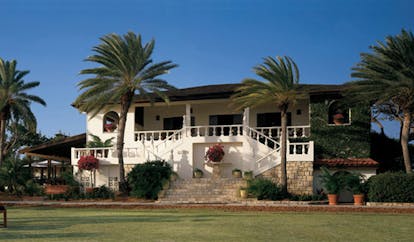 Jumby Bay Antigua estate house exterior hotel building palm trees 