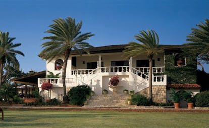 Jumby Bay Antigua estate house exterior hotel building palm trees 