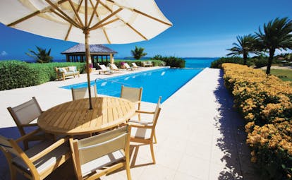 Jumby Bay Antigua tamarind cove pool private pool overlooking sea sun loungers