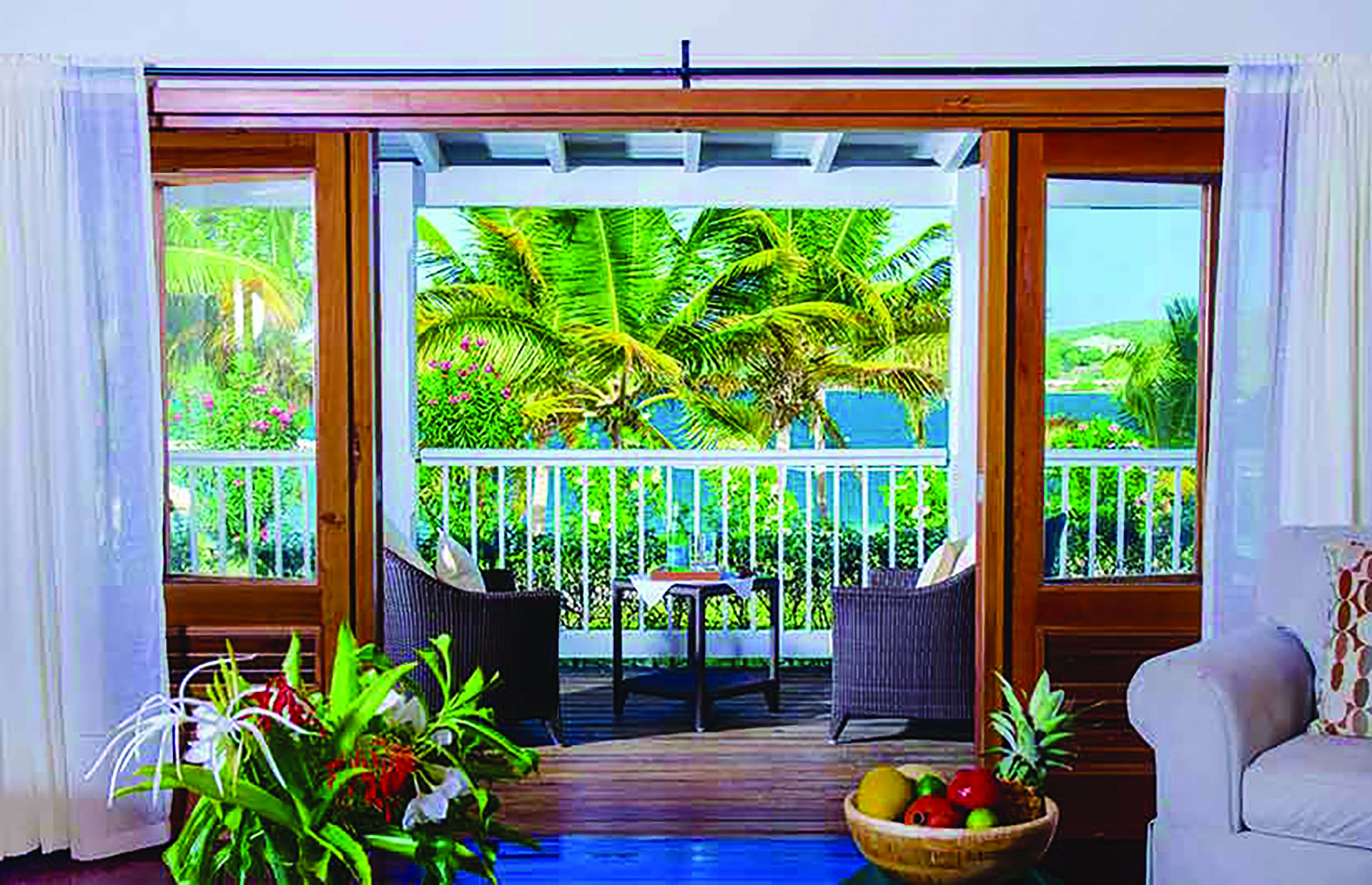 Nonsuch Bay Antigua premium beach suite lounge leading to balcony and outdoor seating overlooking beach
