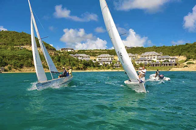 Nonsuch Bay Antigua sailing three boats beach and hotel in background