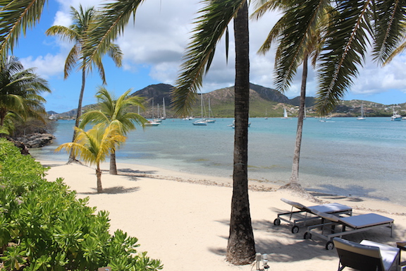 South Point beach, white sandy beach, palm trees, clear blue waters, sun loungers