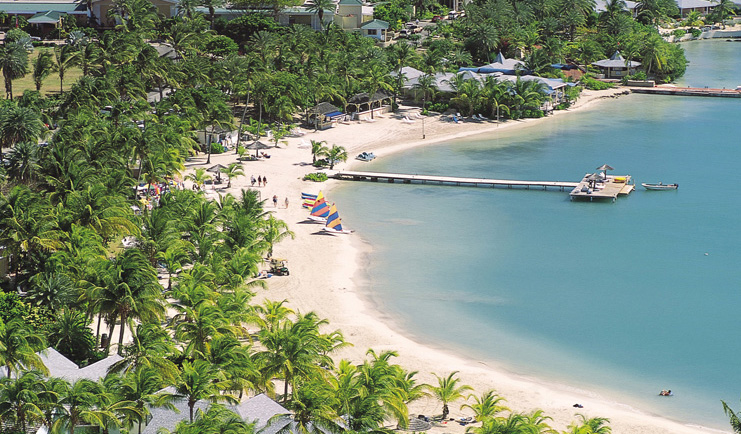 St James's Club Antigua aerial shot of beach sand sea palm trees jetty boats