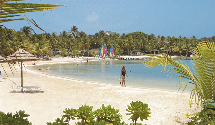 St James's Club Antigua beach woman walking on the sand