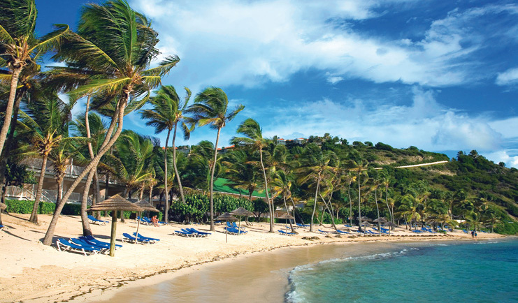St James's Club Antigua beach white sand  sun loungers umbrellas palm trees