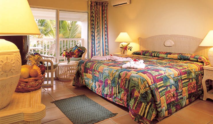 St James's Club Antigua guestroom bed chairs colourful décor