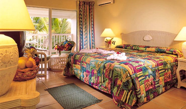 St James's Club Antigua guestroom bed chairs colourful décor
