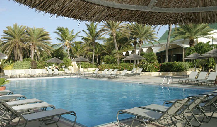 St James's Club Antigua main pool sun loungers beach in background